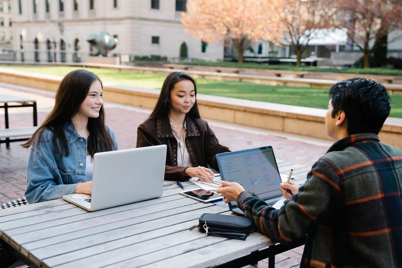 Estudantes reunidos com notebooks em ambiente de aprendizagem